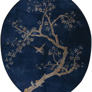 Dark blue oval rug featuring a detailed tree pattern with light-colored blossoms and two birds.