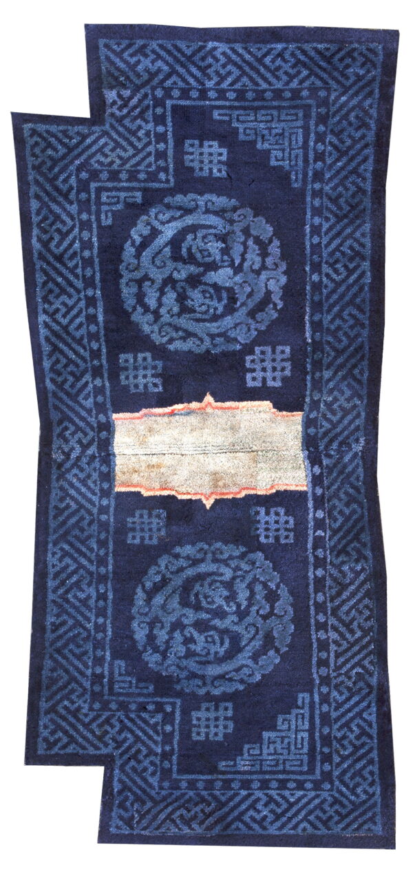 Dark blue rug runner with fading blue patterns and a distinct light tan horizontal band in the middle.