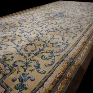 Traditional runner rug featuring blue and gold scrolling floral patterns on a creamy beige ground.