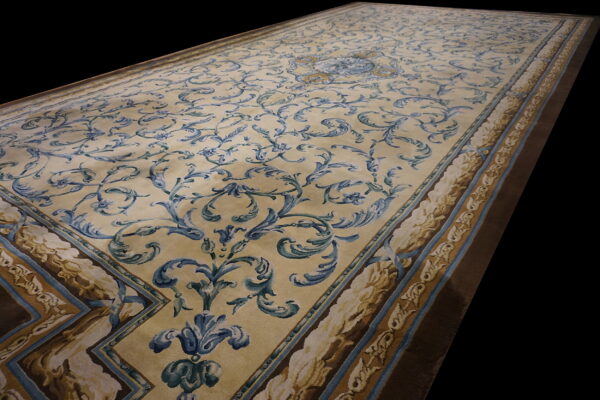 Traditional runner rug featuring blue and gold scrolling floral patterns on a creamy beige ground.
