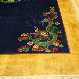 Plush navy rug featuring a colorful green dragon pattern and wide golden yellow outer border on wood flooring.
