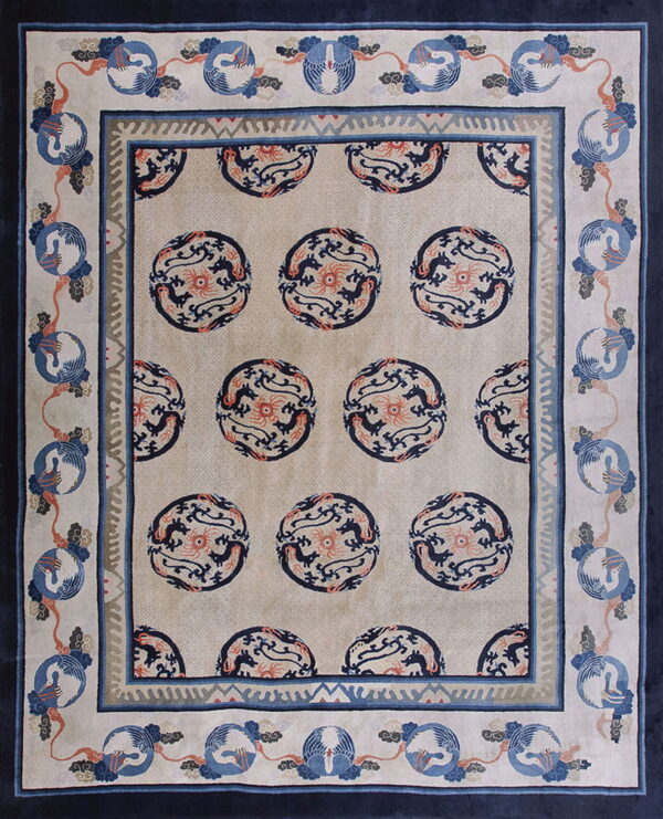 Light beige rug featuring navy circular dragon motifs and a multi-layered border with blue crane designs.