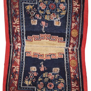 Detailed, dark blue rug with stepped corners, red borders, and a beige panel displaying traditional motifs.