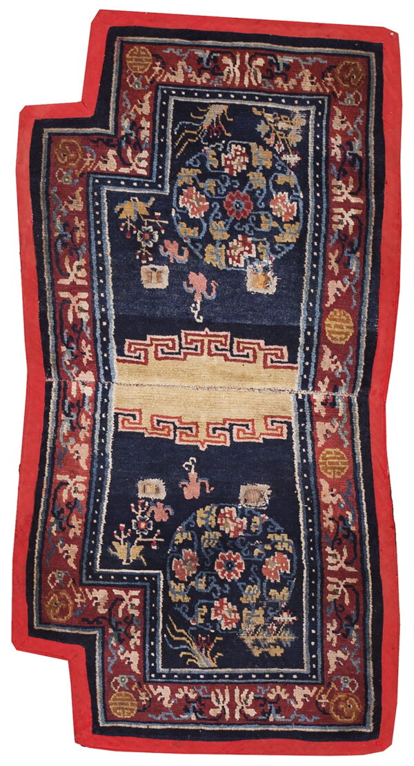 Detailed, dark blue rug with stepped corners, red borders, and a beige panel displaying traditional motifs.