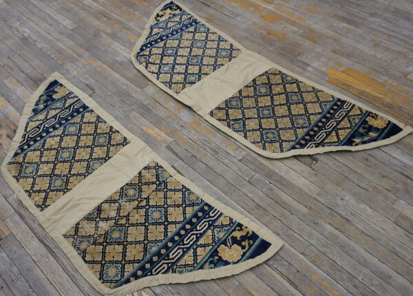 Two low-pile, tapered blue and beige textiles displaying diamond patterns on distressed gray wood.