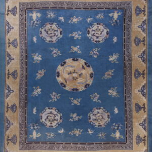 Deep blue rug with tan border featuring circular dragon medallions and geometric key designs.