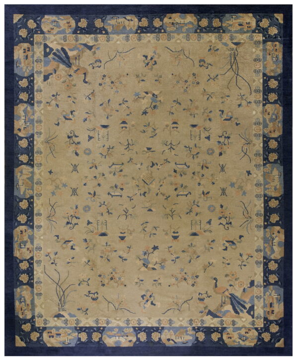 Beige field rug with scattered blue and peach patterns framed by a thick navy blue border.