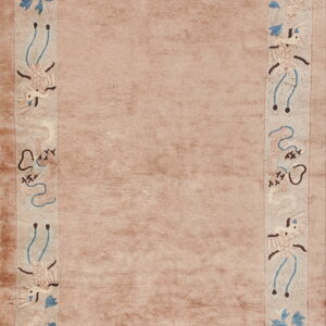 Dusty rose rug with a wide, light decorative border showing stylized birds and pale blue foliage.