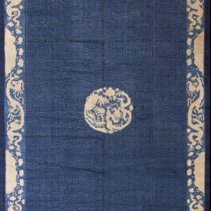 Deep blue rug with beige mythical creatures in the border and a geometric fretwork pattern field.