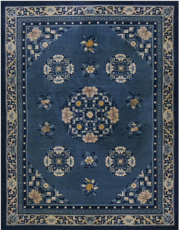 Ornate blue rug featuring a central floral medallion and geometric borders in beige and navy.