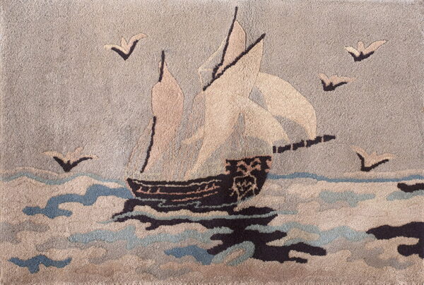 Textured pictorial rug with a sailing ship, birds, and waves in neutral taupe, dark brown, and light blue.
