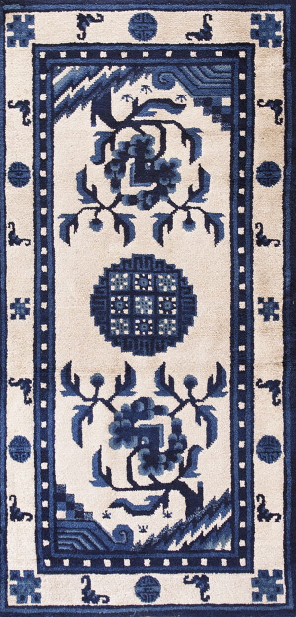 Cream rug with indigo blue complex borders, a central medallion, and stylized floral patterns.