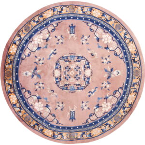Round dusty rose rug with elaborate blue, apricot, and white stylized floral and geometric patterns.