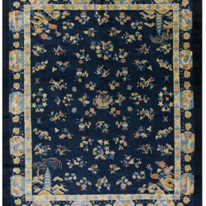 Navy rug features gold and blue flowers, vases, and a detailed border with scenic cartouches.