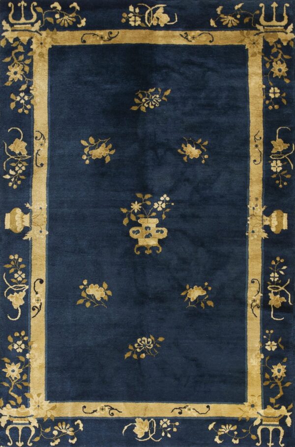 Deep blue rug featuring gold floral clusters and a thick ornamental border with vases.