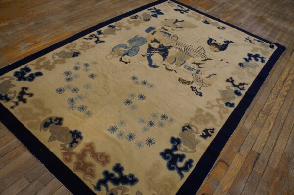Tan field rug with detailed figures and cloud motifs in navy and light blue on distressed wood planks.