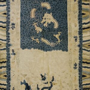 Traditional cream rug with a navy blue cloud medallion featuring a beige dragon and complex, multicolored striped borders.