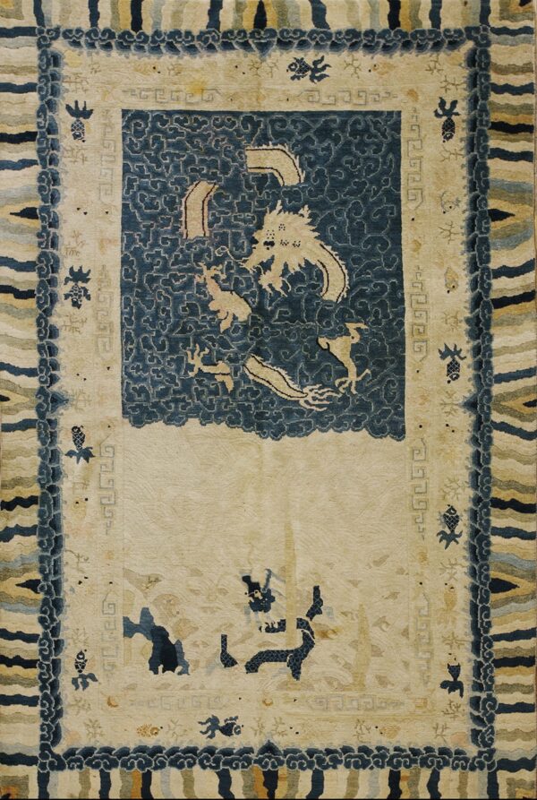 Traditional cream rug with a navy blue cloud medallion featuring a beige dragon and complex, multicolored striped borders.
