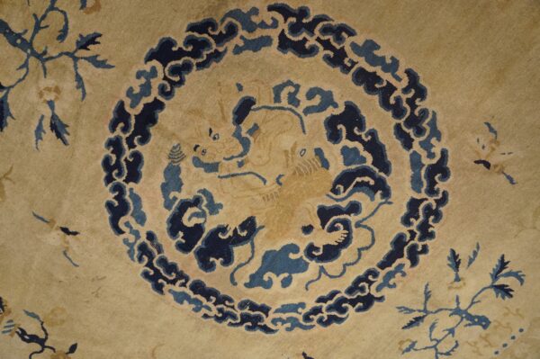 A tan rug detail shows a central stylized creature bordered by dark and medium blue cloud patterns.