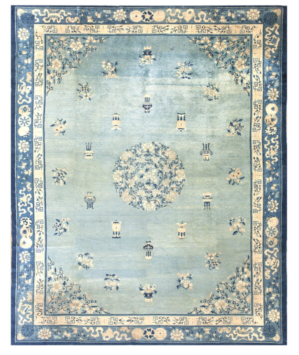Ornate light blue rug with a central medallion and scattered floral designs within navy and cream borders.