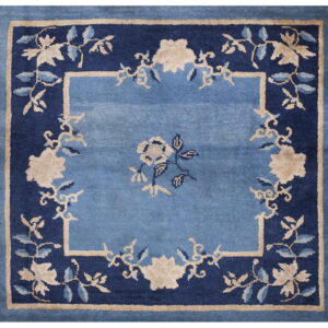 Square rug in light blue, navy blue, and beige featuring a classic floral medallion design.