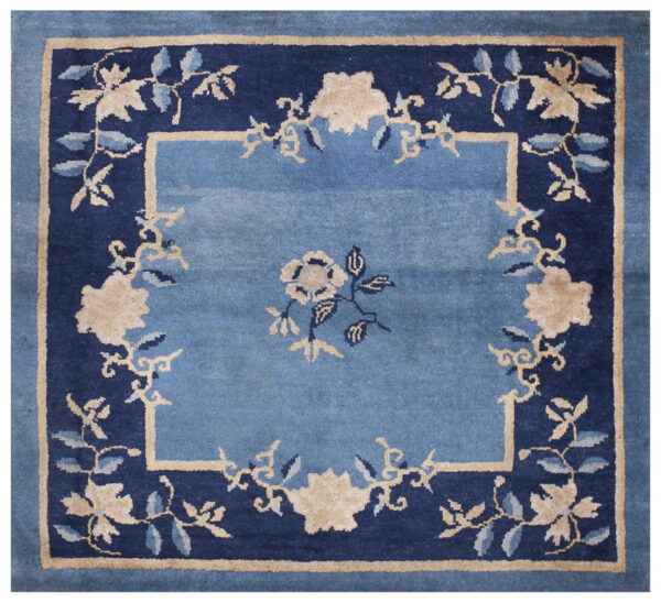 Square rug in light blue, navy blue, and beige featuring a classic floral medallion design.