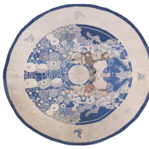 Round rug with a wide cream border and central blue medallion filled with multi-colored floral designs.