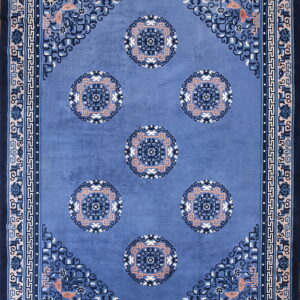 Rectangular blue rug with six salmon, cream, and dark blue central circular medallions and patterned borders.
