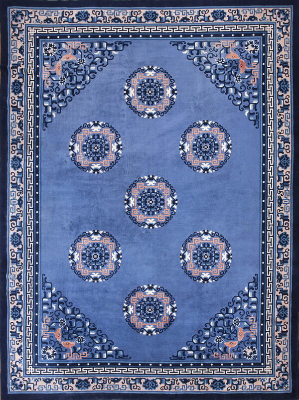 Rectangular blue rug with six salmon, cream, and dark blue central circular medallions and patterned borders.