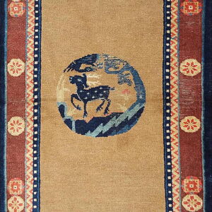 Tan runner rug with a central navy animal circle, blue butterflies, and rust borders with cream geometric medallions.