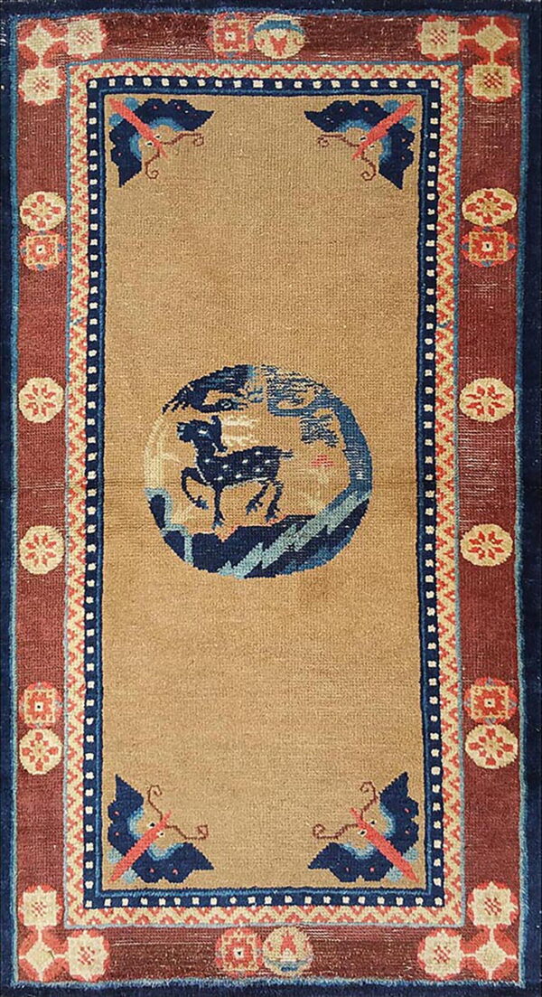 Tan runner rug with a central navy animal circle, blue butterflies, and rust borders with cream geometric medallions.