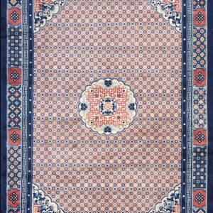 Navy blue and pink traditional rug featuring a dense geometric field and elaborate medallion and border designs.