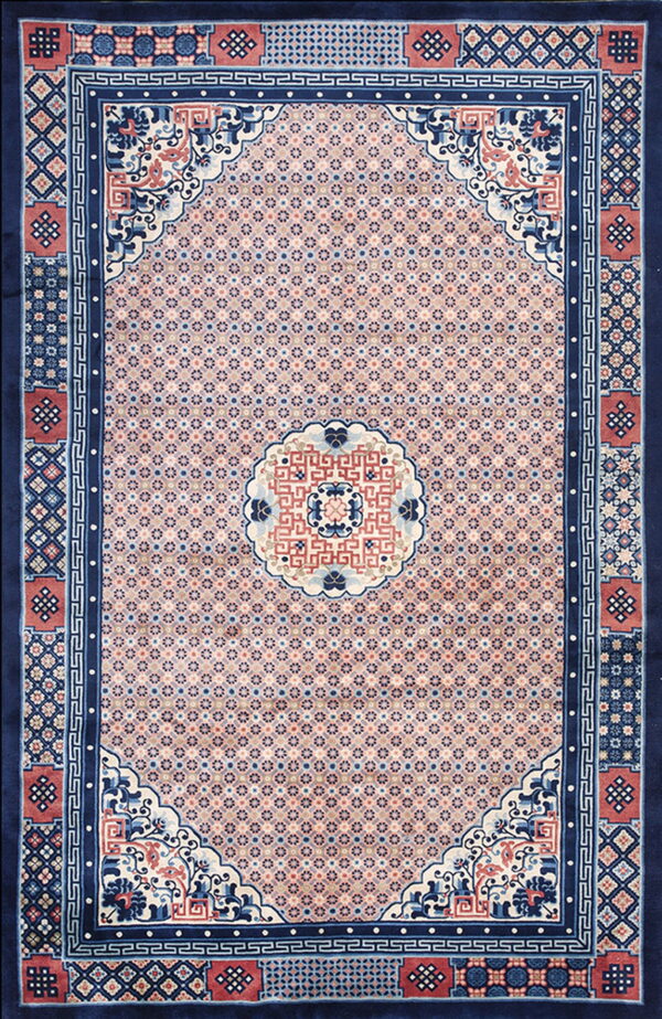 Navy blue and pink traditional rug featuring a dense geometric field and elaborate medallion and border designs.