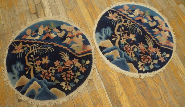Matching round dark blue rugs featuring a colorful mountainous landscape and floral pattern on wood floor.