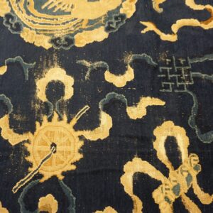 Short pile navy blue rug featuring gold wheel, cloud, and geometric motifs with teal accents.