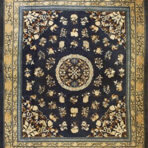 Navy blue rug with a central medallion and scattered traditional motifs in tan, cream, and brown.