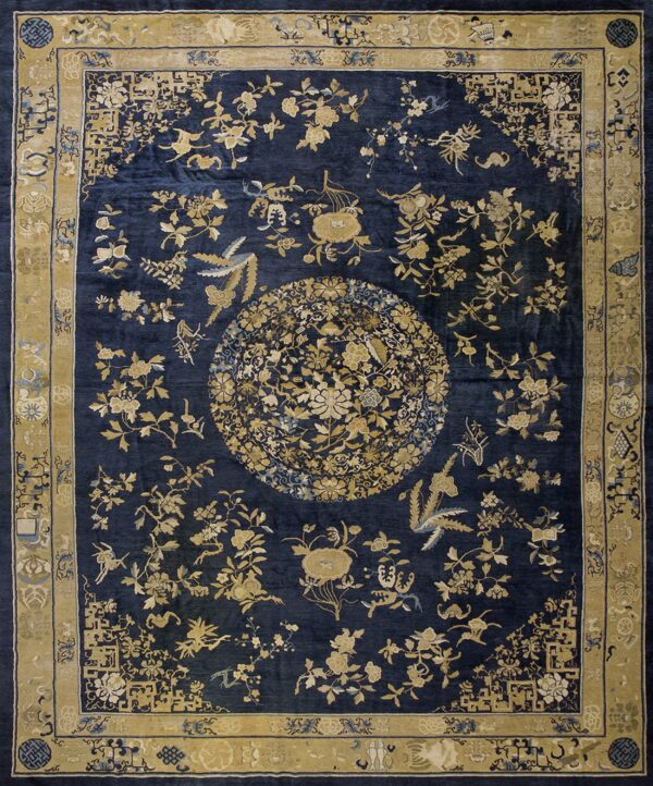 Ornate navy blue rug featuring a large gold floral medallion and a wide patterned border.