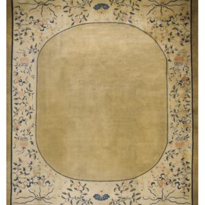 Rectangular tan rug featuring an oval field framed by a decorative border of blue vines and peach flowers.