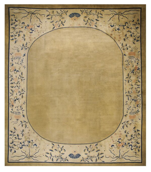 Rectangular tan rug featuring an oval field framed by a decorative border of blue vines and peach flowers.