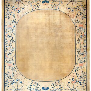 Rectangular low-pile rug with a solid tan oval center and detailed blue and pink floral border.