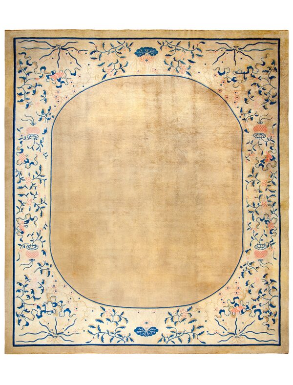 Rectangular low-pile rug with a solid tan oval center and detailed blue and pink floral border.