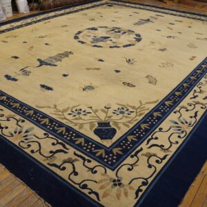 Traditional cream rug with a detailed navy border and scattered blue Chinese motifs on hardwood floors.