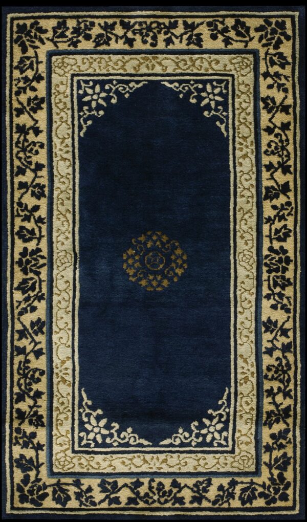 High-pile navy blue runner with detailed beige and gold floral borders and a center medallion.