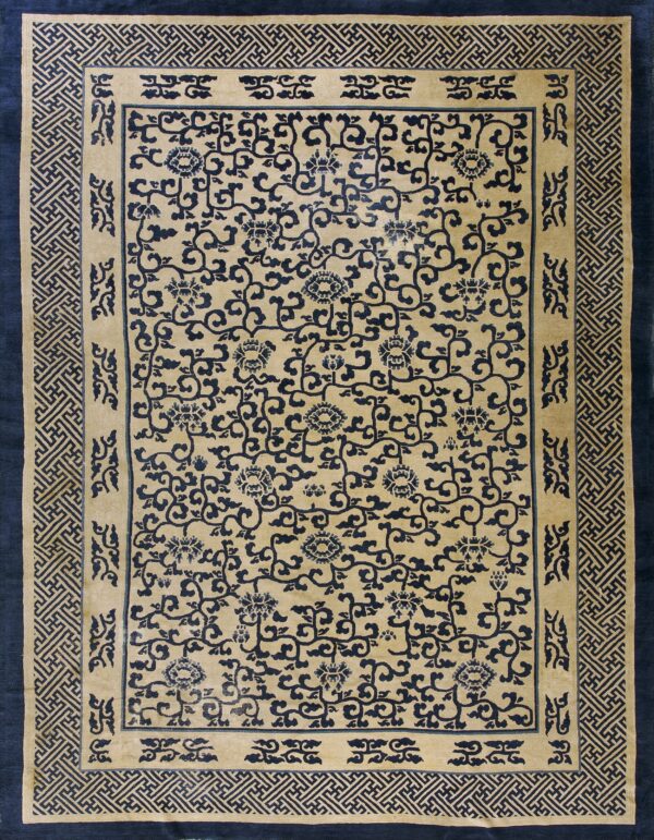 Beige rug with navy blue central scrolling floral pattern and dense geometric key borders.