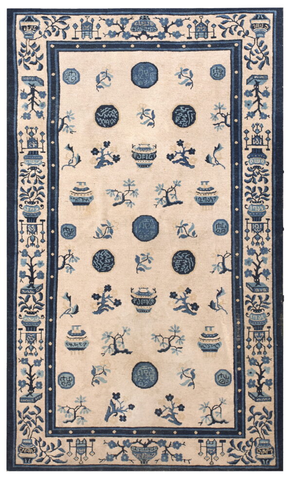Rectangular rug with a cream field and dark blue pattern showing vases, circular motifs, and flora.