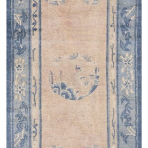 Rectangular rug with a faded beige field, dense blue borders, and stylized floral and circular patterns.
