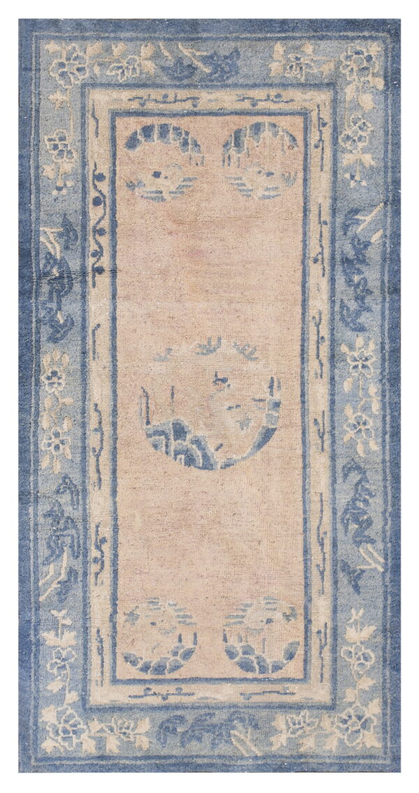 Rectangular rug with a faded beige field, dense blue borders, and stylized floral and circular patterns.