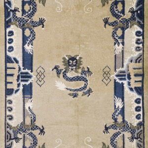 A beige rug with stylized blue and gray dragon motifs surrounding a central dragon design.