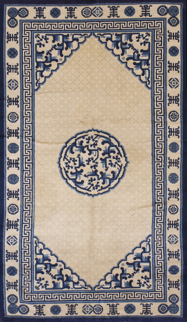 Beige rug featuring a large blue circular medallion framed by detailed geometric borders and symbols.