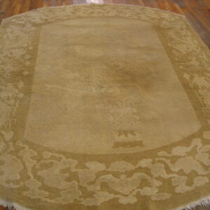 Tan rug with carved patterns of dragons and clouds displayed on wide brown hardwood flooring.
